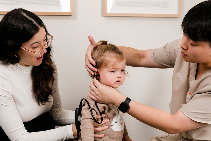 Children's Health Queensland Healthy Hearing team examining a toddlers hearing.