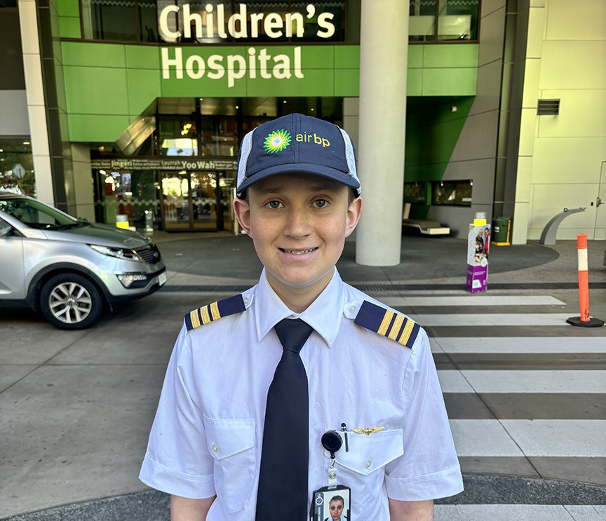 Byron in front of Queensland Children's Hospital in pilot uniform