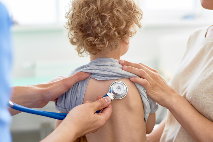 Doctor holding stethoscope to a pre-school aged child's back